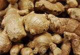 Fresh ginger root on wooden cutting board, Healing Turmeric powder with ginger root, Ginger root sliced showing texture, Anti-inflammatory spices flat lay