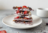 frozen yogurt bark with beauty berries and fresh berries on parchment paper, coconut yogurt bark with maqui acai acerola antioxidant berries, healthy frozen dessert beauty berry pink purple yogurt bark